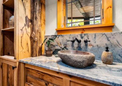 Bathroom with natural stone sink bowl.