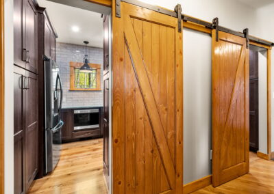 Kitchen pantry with sliding barn doors.